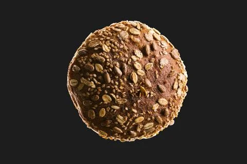 Top view macro of bread isolated on black background. Dark and moody food con Stock Photos