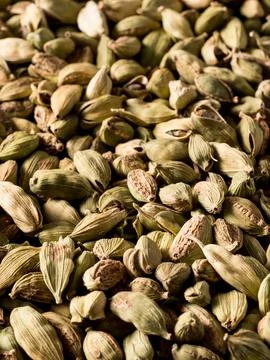 Top view macro closeup on plenty of green cardamom spice. Stock Photos