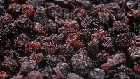 Top view, macro. Heap of dried raisins, as the camera moves on a slider. Stock Footage 292536618