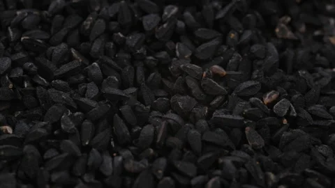 Top view, macro. Heap of dry black cumin seeds, slider shot. Видео 292508771