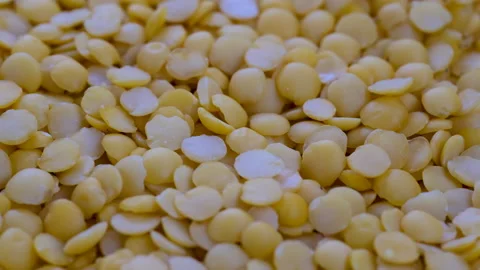 Top view, macro. Heap of raw uncooked yellow lentils, slider shot. Stock Footage 292519276