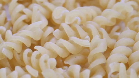 Top view, macro. Pile of uncooked Fusilli, italian spiral pasta. Slider shot Stock Footage 292521465
