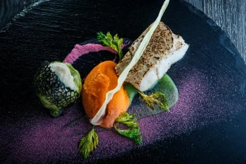 Top view macro roasted white fish served with carrot puree Fotos Stock