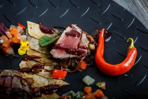 Top view macro two pieces of grilled meat with red pepper and sauce Stock-Fotos