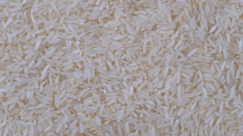 A top-view macro video of a heap of dry uncooked white rice as the camera gli Stock Footage 285904868