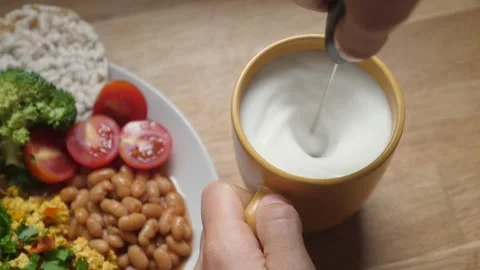 Top view of making foam of soya milk with handheld electric milk foamer Stock Footage 140010453