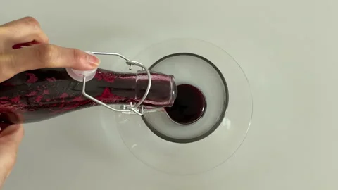 Top view of making hibiscus tea with hibiscus syrup and hot water Stock Footage 189182593