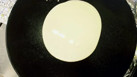 Top view of making russian pancake on professional pan Stock Footage 154931784