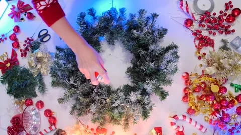 Top view of making a Xmas wreath using artificial snow sprayed on fir branches Video stock 288283074