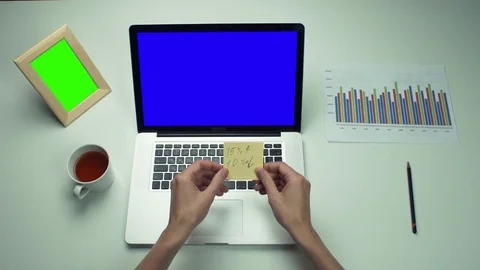 Top view male hands using sticky notes and laptop with green screen Stock Footage 82888452