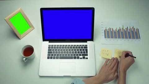 Top view male hands using sticky notes and laptop with green screen Video stock 82888589