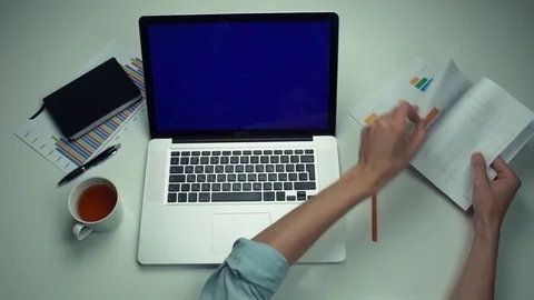 Top view male hands using graphic tab and laptop with green screen at white desk Stock Footage 82891352