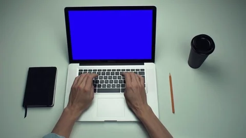 Top view male hands using laptop computer with green screen at white desk Stock Footage 82892544