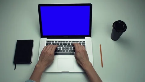 Top view male hands using laptop computer with green screen at white desk Stock Footage 82892697