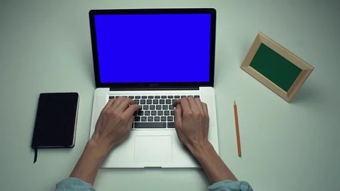 Top view male hands using laptop computer with green screen at white desk Stock Footage 82893137