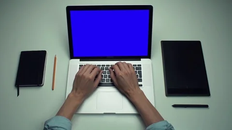 Top view male hands using laptop computer with green screen at white desk. Stock Footage 82894490