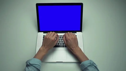 Top view male hands using laptop computer with green screen at white desk. Stock Footage 82894728