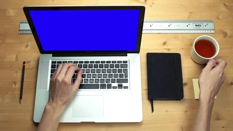 Top view male hands using laptop with green screen at wooden desk Stock Footage 82895973