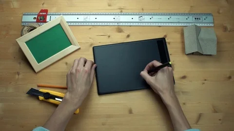 Top view male hands using digital graphic tablet at wooden desk. Stock Footage 82899836