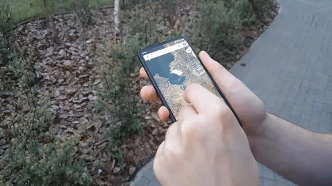 Top view on male hands using smartphone on the street. Man using map 動画素材 125876608