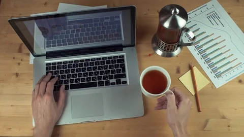Top view male hands working with printed graphs using laptop with green screen Stock Footage 82887617