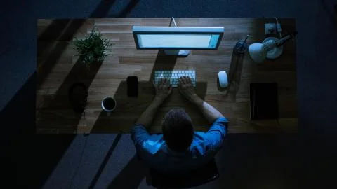 Top View of Male Programmer Working at His Desktop Computer at Night. Stock Photos