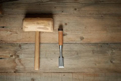 Top view, mallet and chisel on wooden workbench Stock Photos