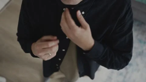 Top view of man adjusting collar in minimalist style 스톡 동영상 318921561