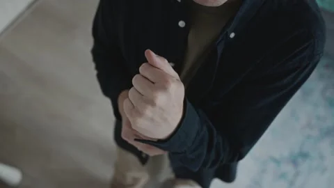 Top view of man adjusting sleeve during morning ritual Stock Footage 316580923