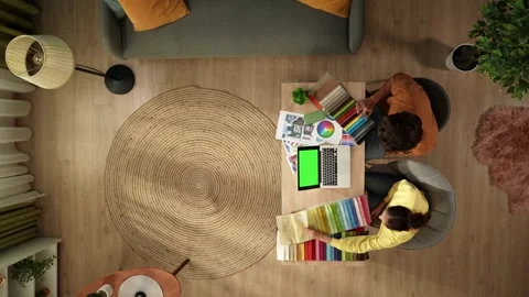 Top view of a man and a woman working from home. Young designers are comparing Stock Footage 260057853