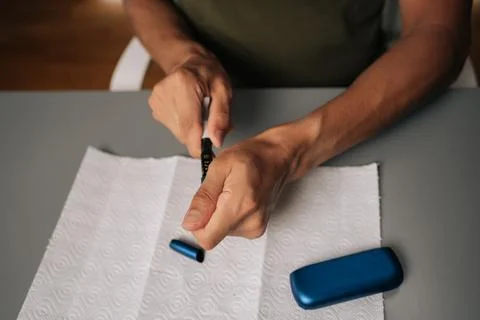 Top view of man cleaning electronic cigarette emphasizing importance of hygiene Stock Photos