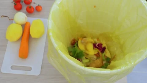 Top view of a man composting vegetable waste in the kitchen Stock Footage 255979274