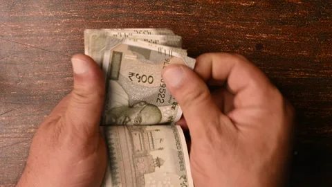 Top View of a Man Counting 500/- Rupee Notes on Wooden Table – Finance Footage Stock Footage 329353837