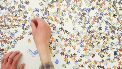 Top view of a man doing a jigsaw puzzle Video stock 128370524