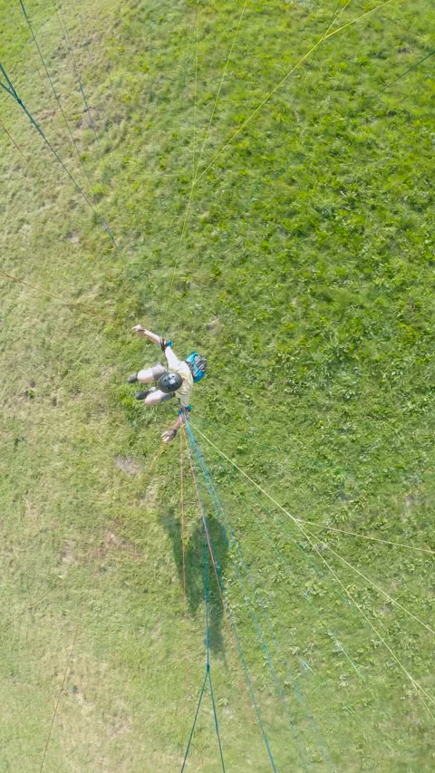 Top view from man flying the extreme paragliding. Interlaken, Switzerland. Stock Footage 237511607
