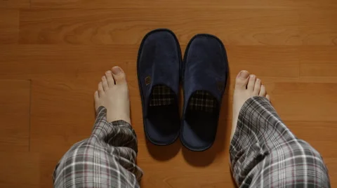 TOP VIEW: Man gets up from a bed in the night then wears a slippers and goes Stock Footage 65173165