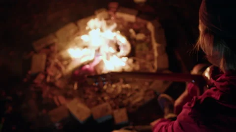 Top view of a man with a guitar by the fire. Hipster sings and plays for friends Stock Footage 230899872