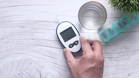 Top view of man hand putting diabetic measurement kits on table Stock Footage 135466100