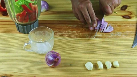 Top view on man hands cut by knife on slices half of purple onion on wooden Stock Footage 143555549