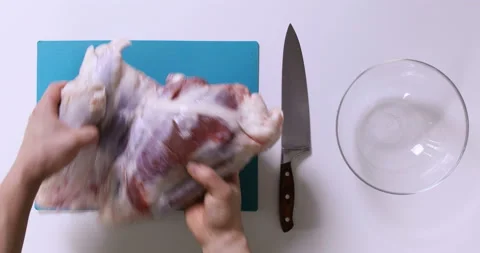 Top view of man hands cutting fresh meat on white table Stock Footage 96678840