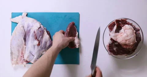Top view of man hands cutting fresh meat on white table Stock Footage 96679117