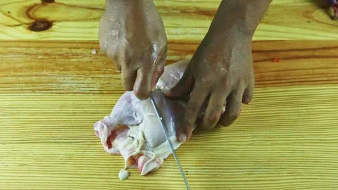 Top view on man hands by knife start to slice half of raw chicken on wooden Stock Footage 143555649