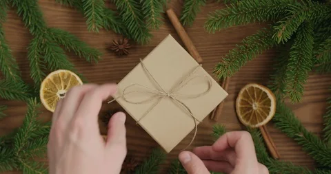 Top view man hands open empty brown gift box on ash surface with christmas Stock Footage 119124816
