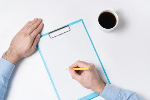 Top view of man hands, papers and cup of coffee. Man writes on paper. Copy sp 스톡 사진