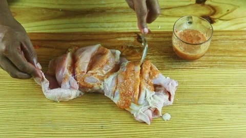 Top view on man hands by spoon marinate half of raw chicken with spicy sauce Stock Footage 143087868