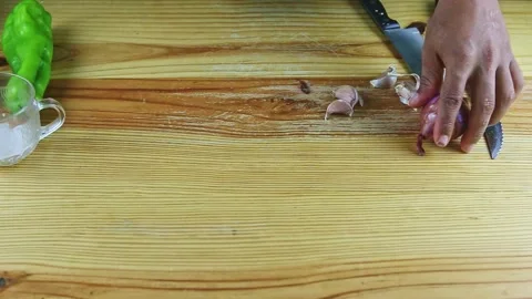 Top view on man hands take away purple onions and garlic pieces from wooden Stock Footage 143555365