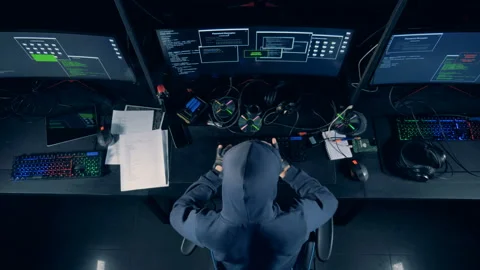 Top view of a man in a hoodie hacking a computer Stock Footage 104205957