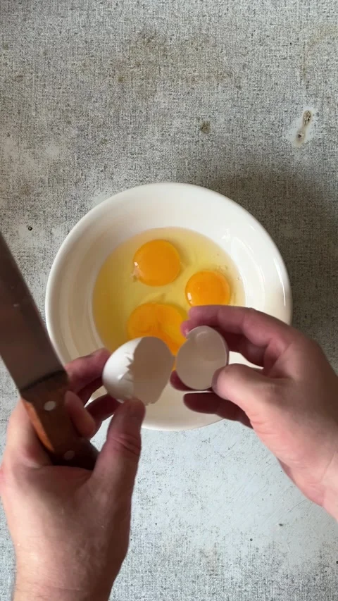 Top view. Man with knife breaks chicken egg at kitchen Stock Footage 278119258