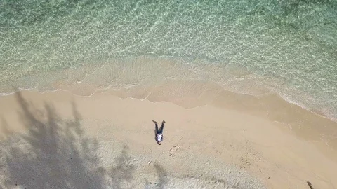 Top view of man lay down in the beach with clean and clear sea surface Stock Footage 113259648