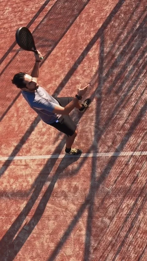 Top view of a man learning to play paddle tennis on an outdoor court. Stock Footage 310104297